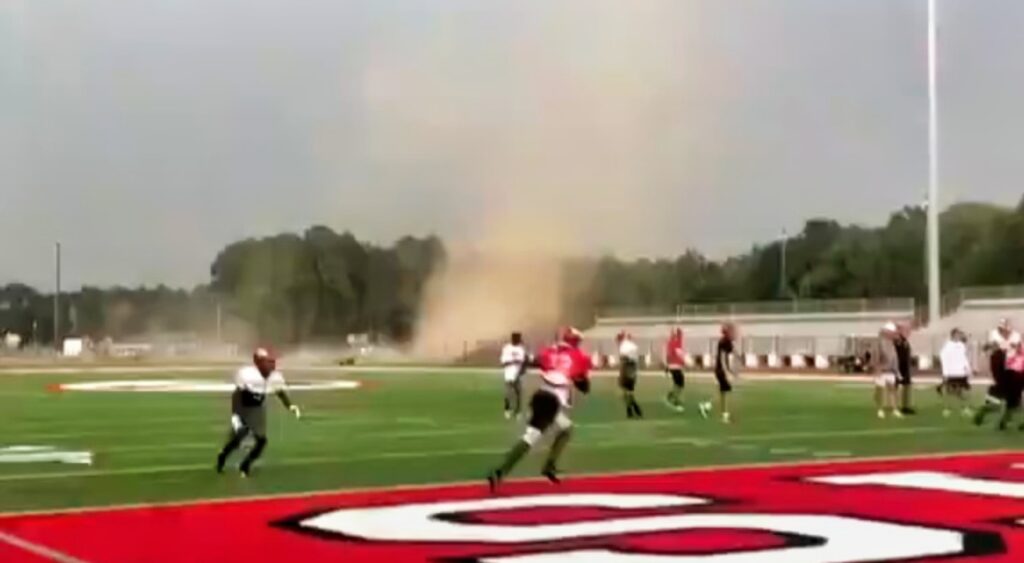 Theodore High School football players running from a tornado