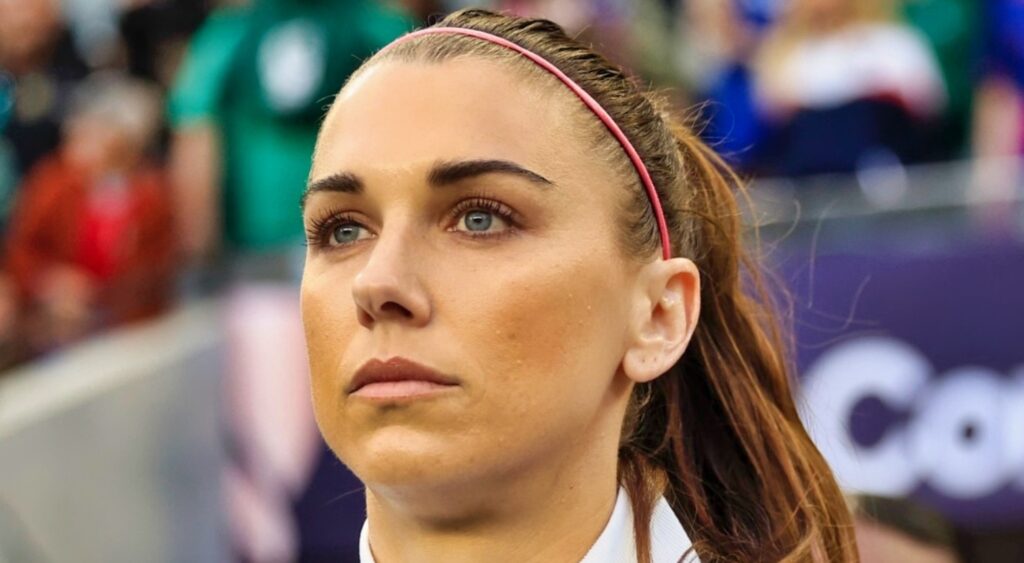 Alex Morgan looks on.