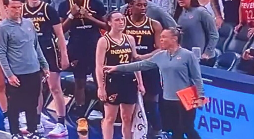 Caitlin Clark seen on jumbotron talking to Seattle Storm players.