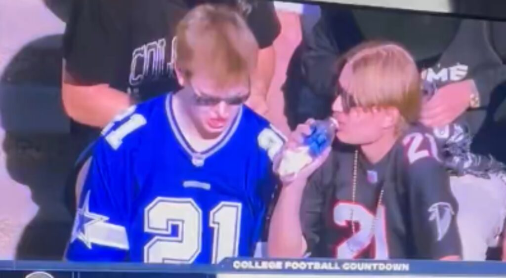 Colorado Buffaloes fans drinking a beverage at game.