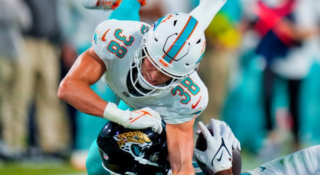 White NFL Cornerback Ethan Bonner of the Miami Dolphins makes a tackle.