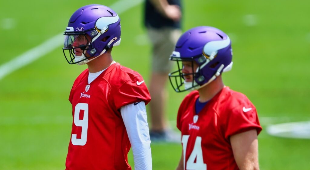 JJ McCarthy and Sam Darnold looking on at practice.