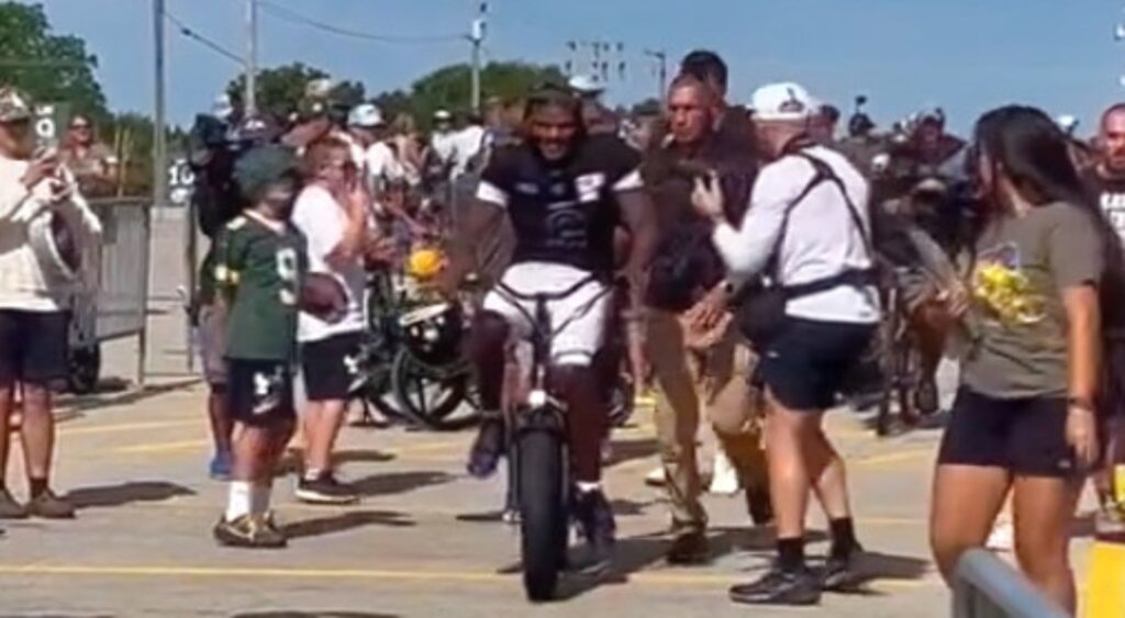 Lamar Jackson of Baltimore Ravens riding a bike.