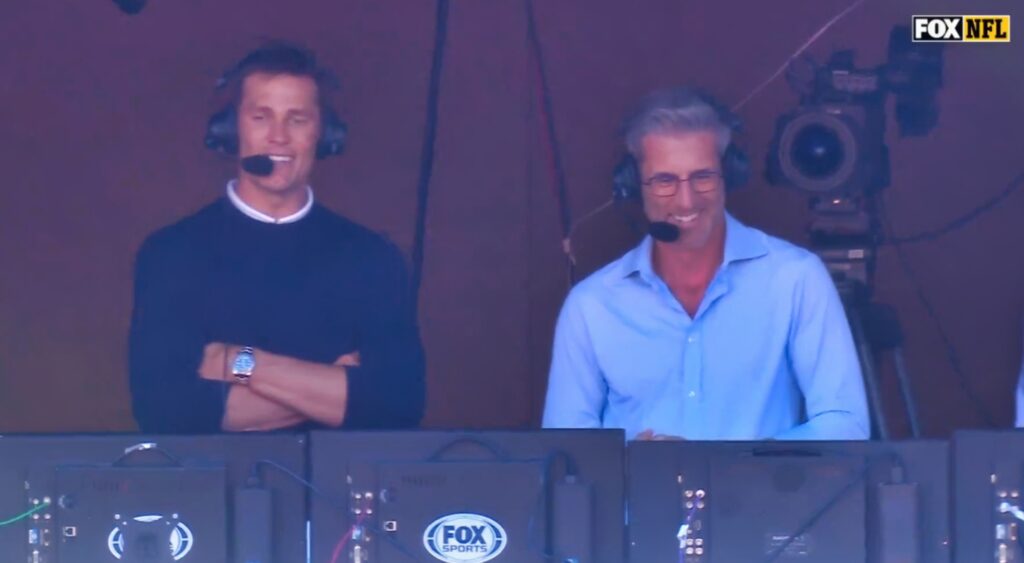 Tom Brady and Kevin Burkhardt speaking in FOX NFL broadcast booth.