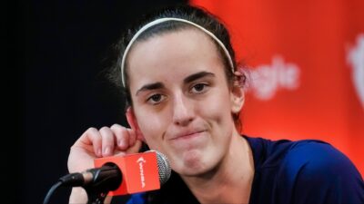 Caitlin Clark looks on during a press conference.