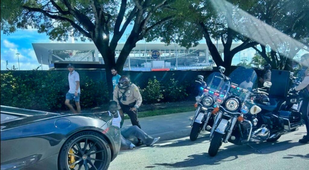 Calais Campbell and Tyreek Hill being arrested