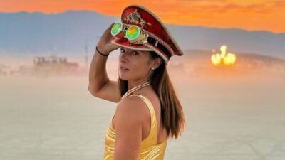 Danica Patrick posing in gold uniform