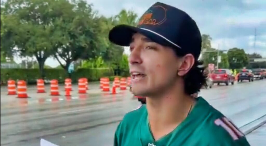 Miami Dolphins fan holding up a sign outside the stadium.