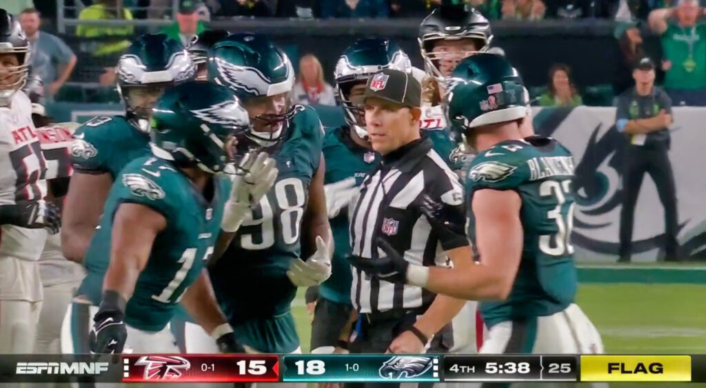 Eagles players gather around the ref.