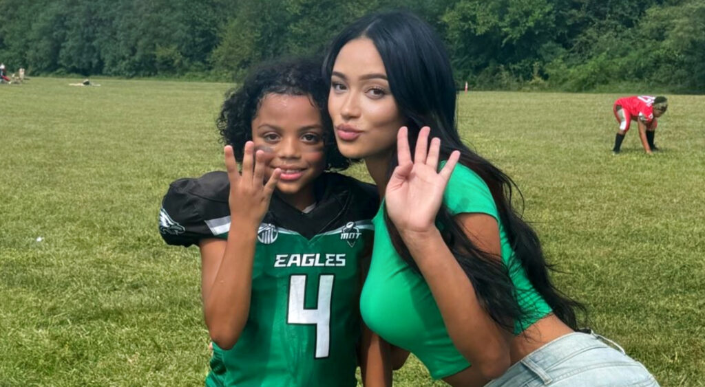 Football Mom posing with son