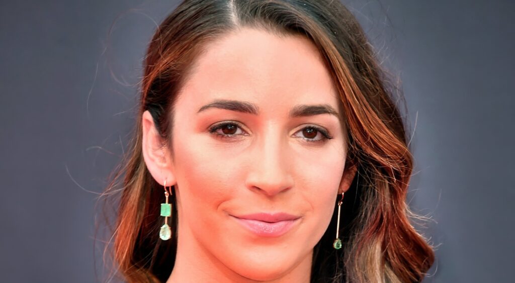 Aly Raisman poses on the red carpet.