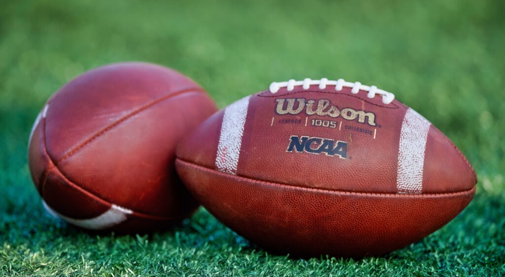 NCAA footballs on the field. UNLV quarterback Matthew Sluka left the team.