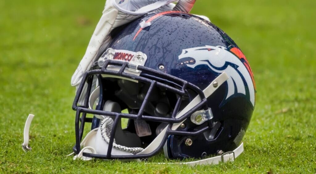 Denver Broncos helmet shown on field.