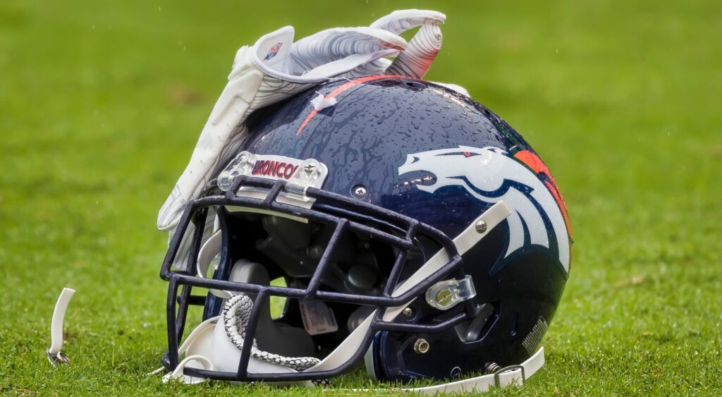 Denver Broncos helmet shown on field. The team will be without Alex Singleton for the rest of 2024.