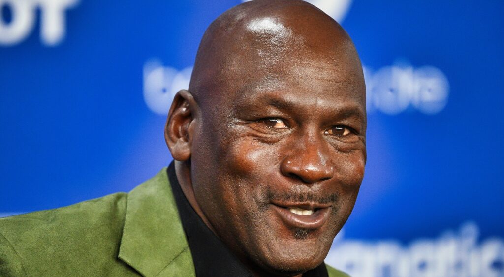 Michael Jordan smiles at a press conference.