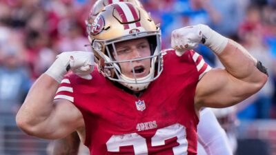 Christian McCaffrey flexing muscles