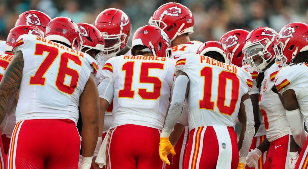 Kansas City Chiefs players in huddle