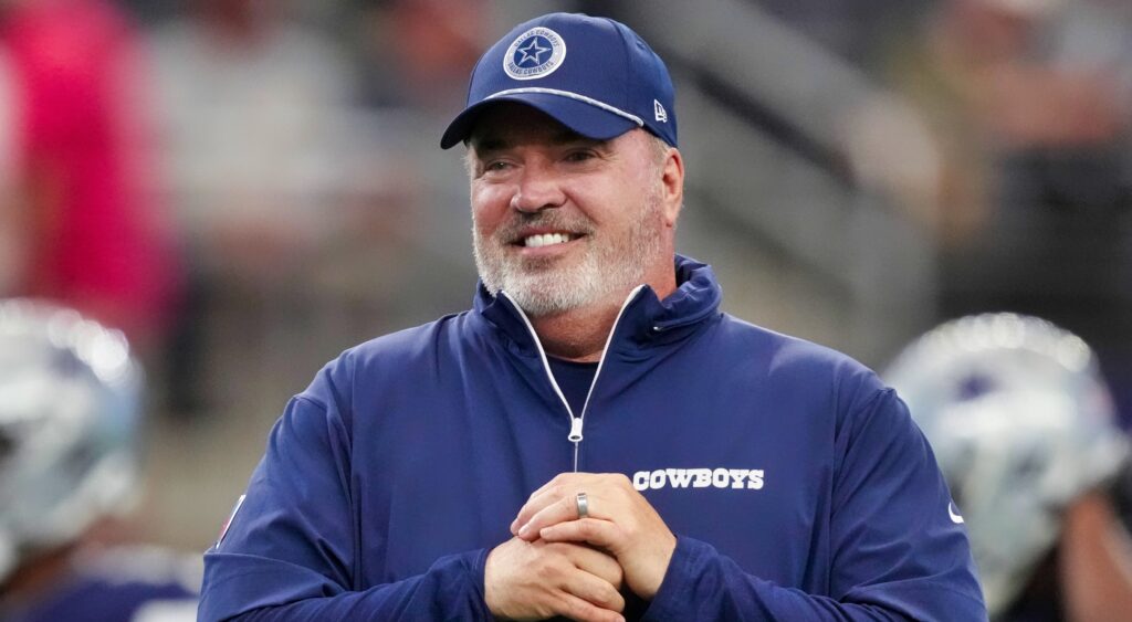 Mike McCarthy smiling during a game.