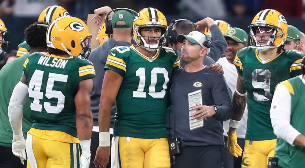 Jordan Love and Matt LaFleur of Green Bay Packers takling during game.