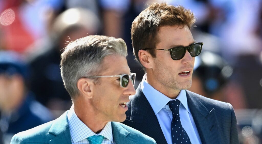 Kevin Burkhardt and Tom Brady looking on.