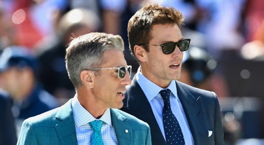 Kevin Burkhardt and Tom Brady looking on before game.