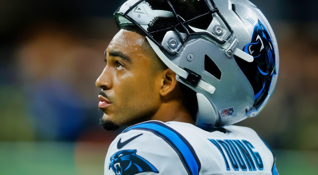 Bryce Young looks on with his helmet on his head.