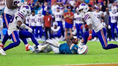 Tua Tagovailoa on ground surrounded by Bills players