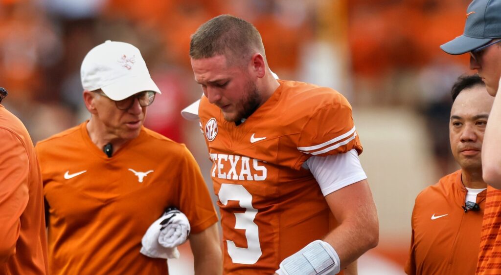 Quinn Ewers of Texas Longhorns walking off field.