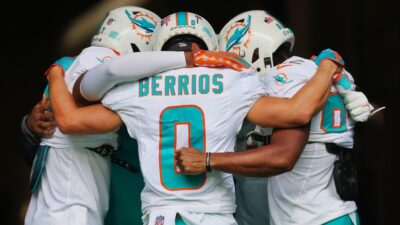 Braxton Berrios huddling with teammates