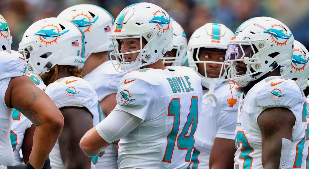 Miami Dolphins players in the huddle