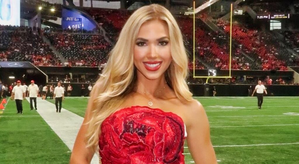 Gracie Hunt posing in red top on field