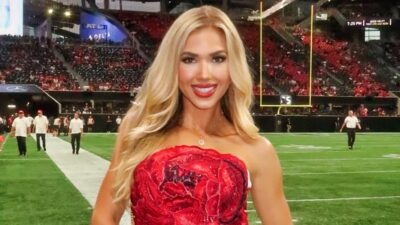 Gracie Hunt posing in red top on field