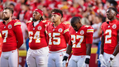 Harrison Butker, Wanya Morris, Patrick Mahomes, Chamarri Conner and Joshua Williams listen to the National Anthem.