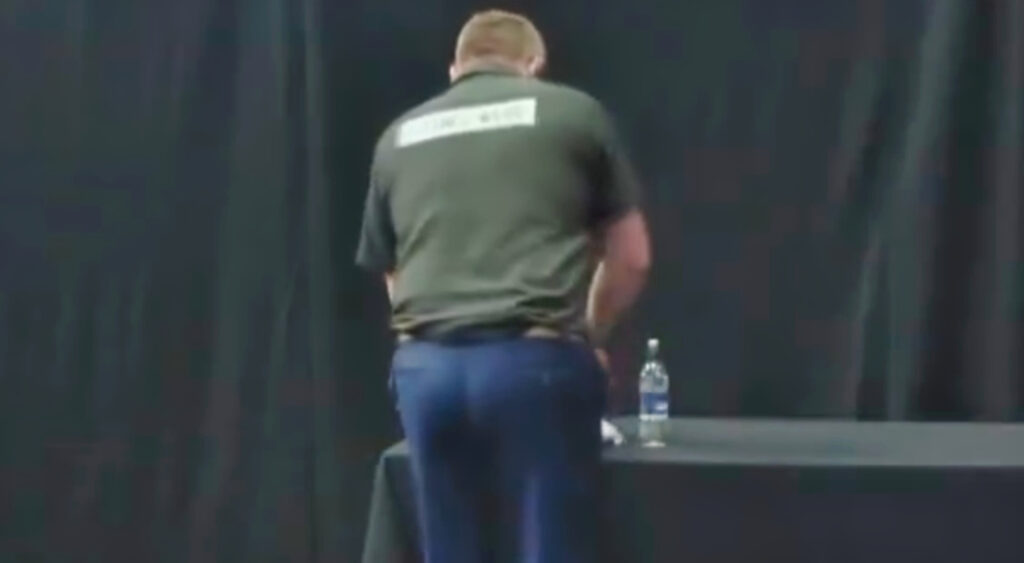 James Wade standing near a table