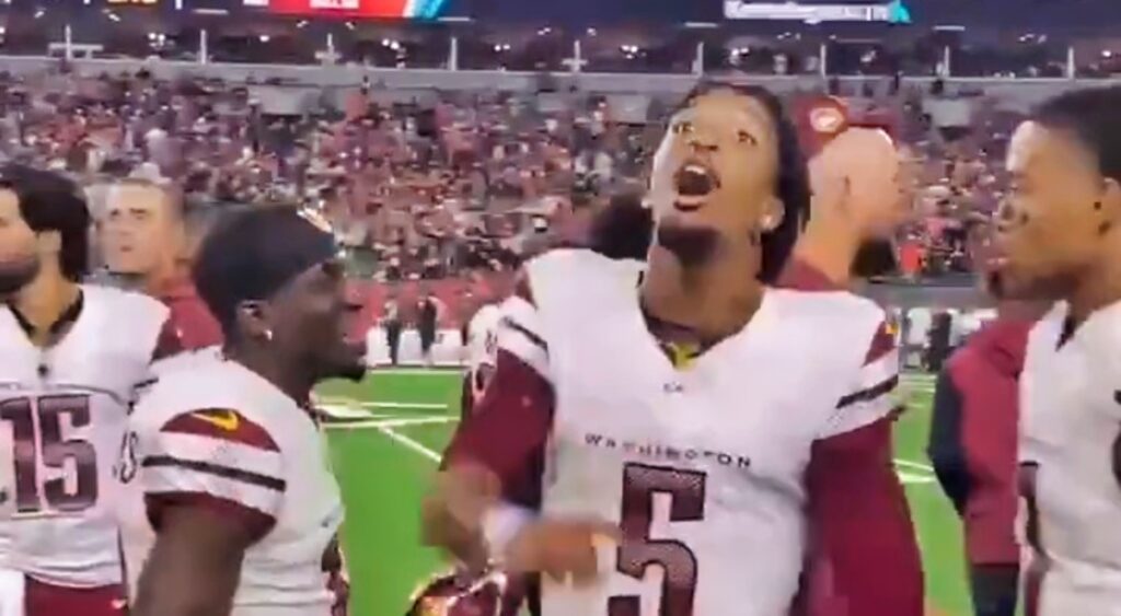 Jayden Daniels yelling at Bengals fans from the sideline.