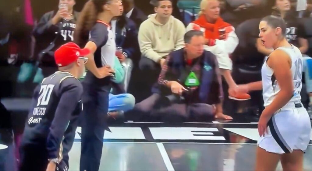 Spike Lee and Kelsey Plum jawing at each other during a game.