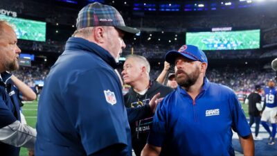 Brian Daboll head coach of the Giants shakes hands with Mike McCarthy head coach of the Cowboys.