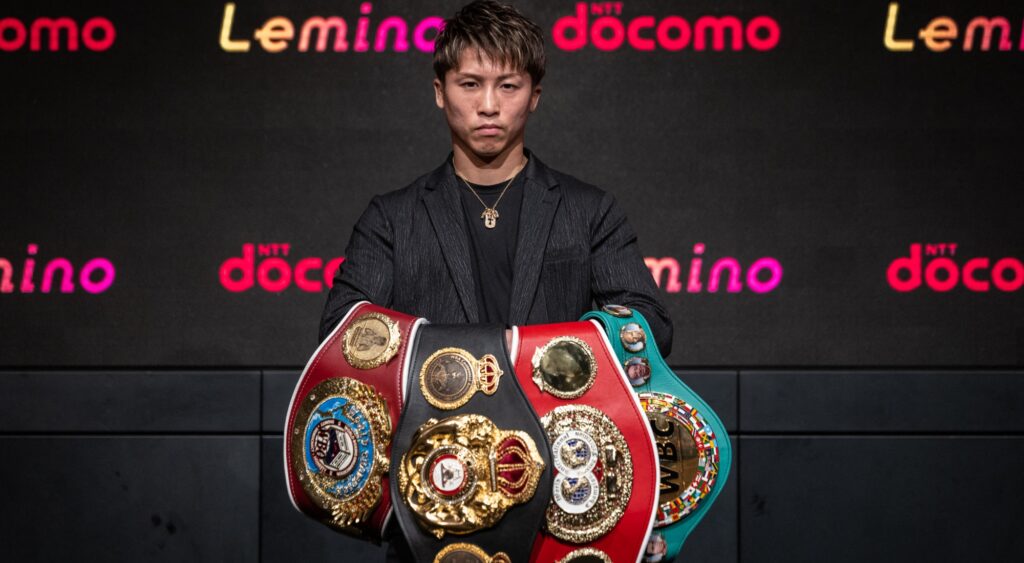 Naoya Inoue holding his belts