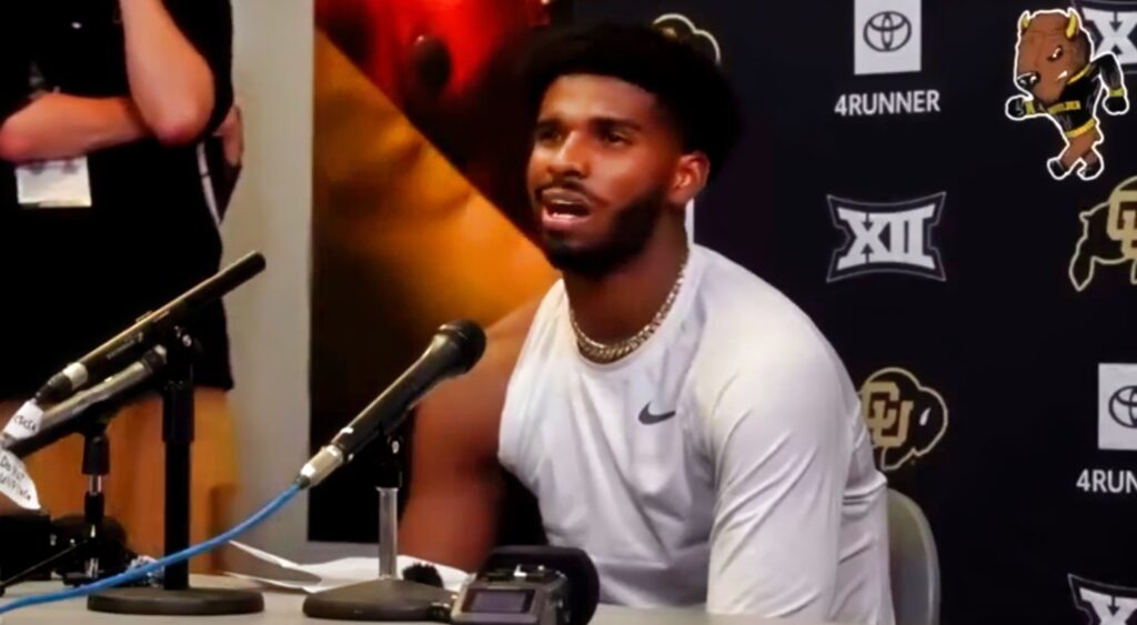 Shedeur Sanders speaking at a press conference.