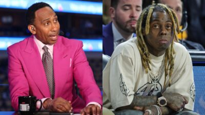 Stephen A Smith in pink suit and Lil Wayne sitting courtside