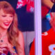 Taylor Swift sitting next to Ed Kelce