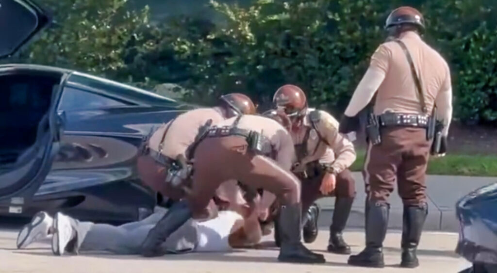 Tyreek Hill being detained by police