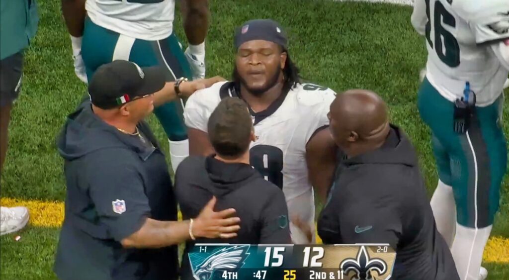 Jalen Carter of Philadelphia Eagles being held back by coaches.