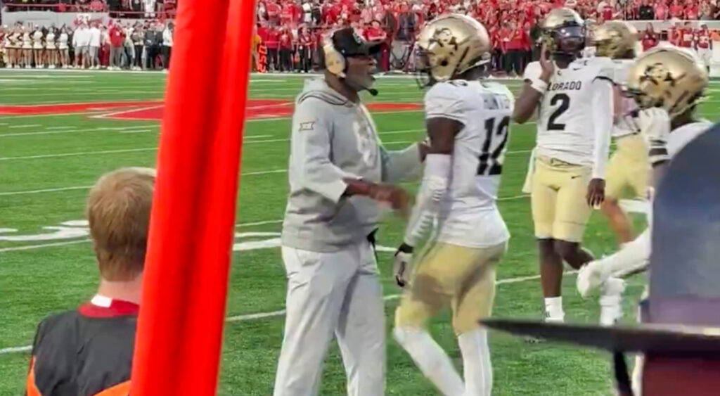 Travis Hunter talking to Deion Sanders during Colorado Buffaloes game.