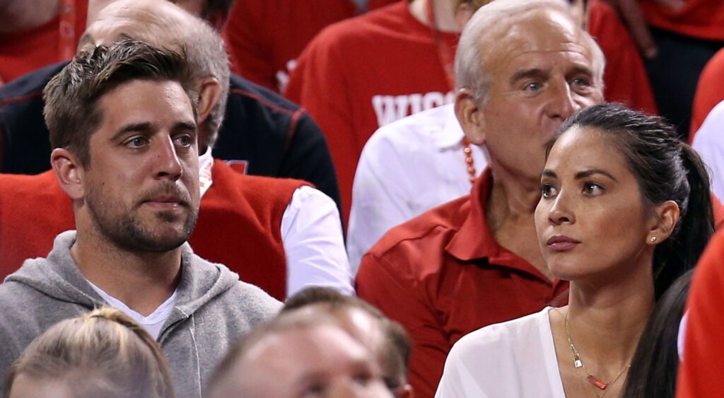 Aaron Rodgers and actress Olivia Munn look on during the game between the Wisconsin Badgers and the Duke Blue Devils 