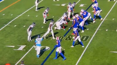 Amari Cooper on field with Bills and Titans players