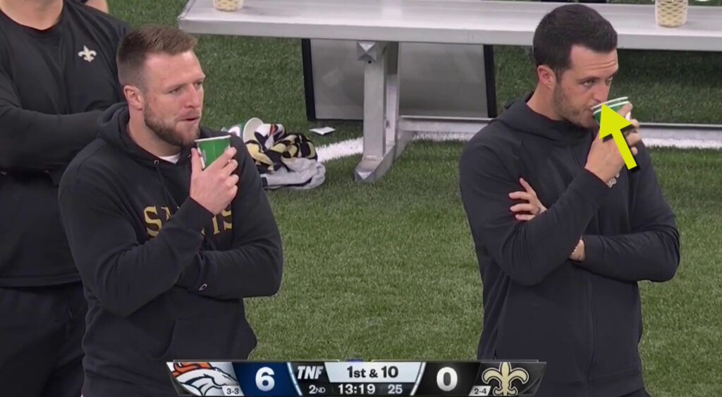 Derek Carr drinking from cup on sideline