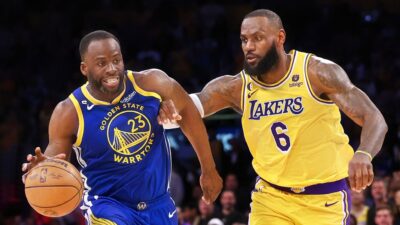 Draymond Green of the Golden State Warriors dribbles as he is chased by LeBron James of the Los Angeles Lakers during a 104-101 Lakers win in game four of the Western Conference Semifinal Playoffs