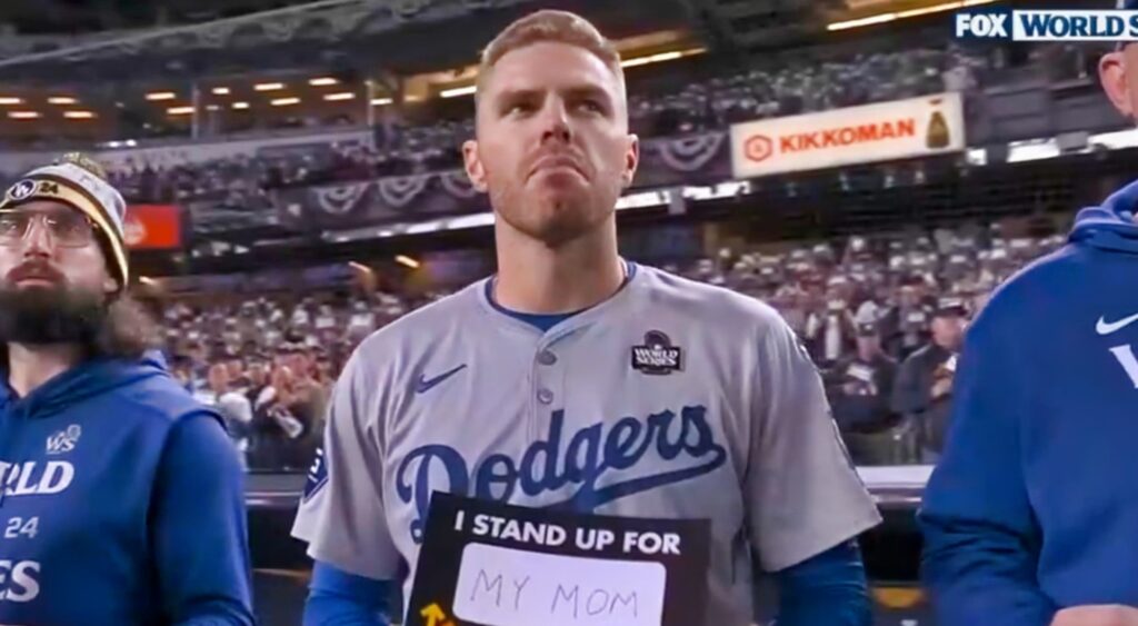 Freddie Freeman standing on field in front of Yankees fans