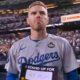 Freddie Freeman standing on field in front of Yankees fans